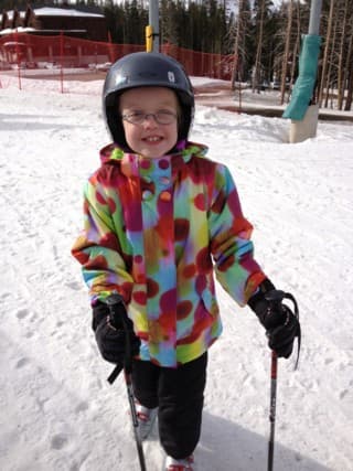 A young skier on a groomed run